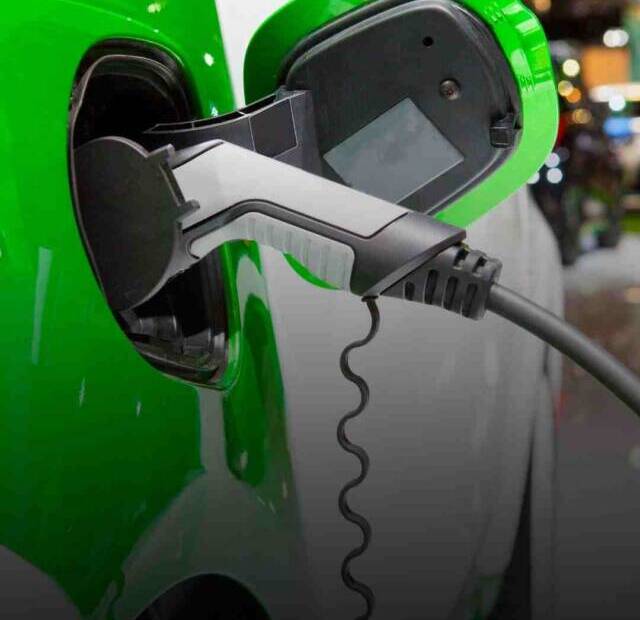 Image of electric car in India while it is being charged using a EV charger