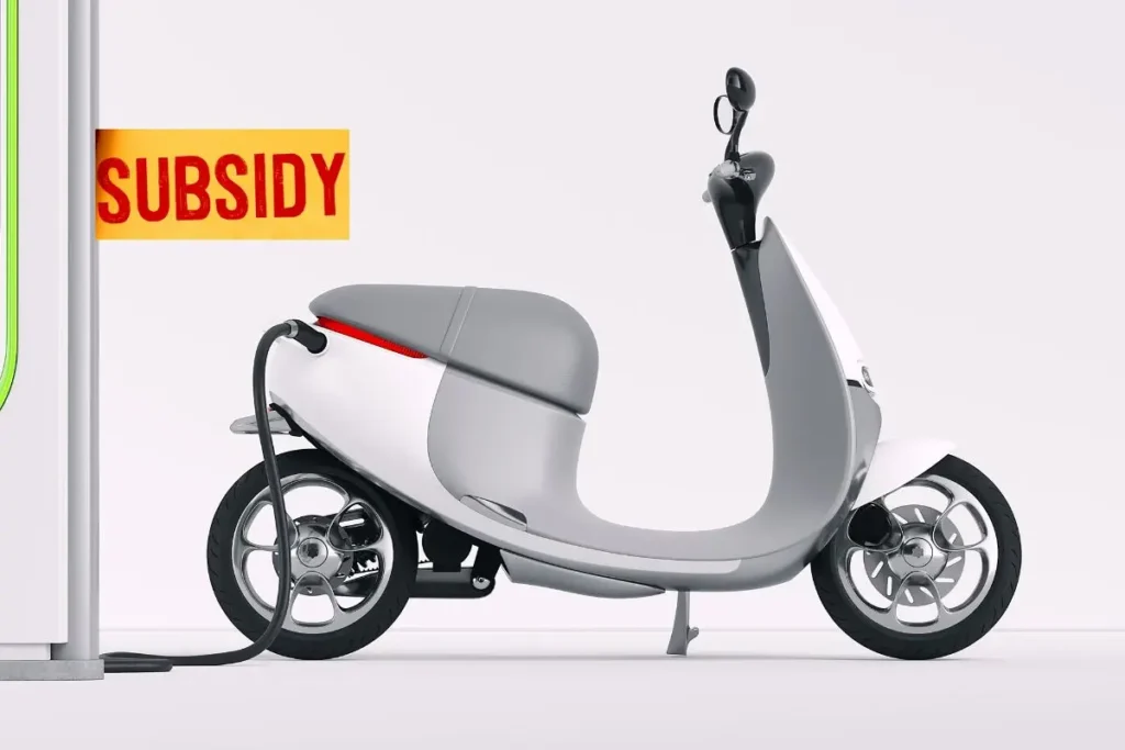 White electric scooter while charging in an EV charging station
