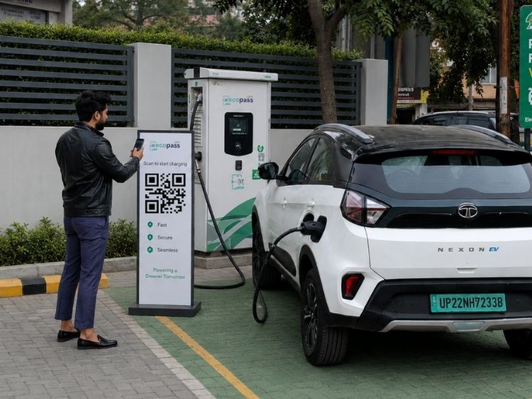 a person scanning a payment QR at a UPI EV charging station